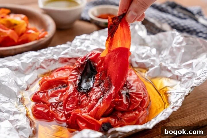 peeling skins off the red bell peppers for Matbucha