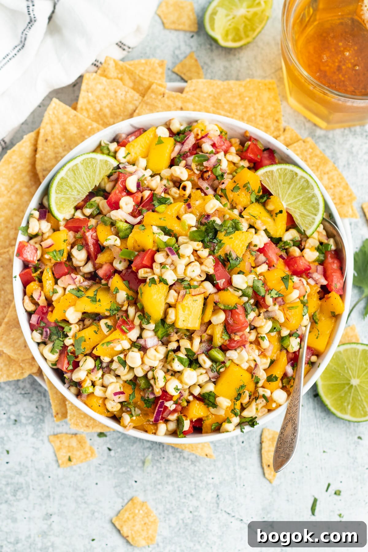 Mango Grilled Corn Salsa Recipe for Summer Parties and BBQs 3 Picture of a bowl with mango corn salsa and chips.