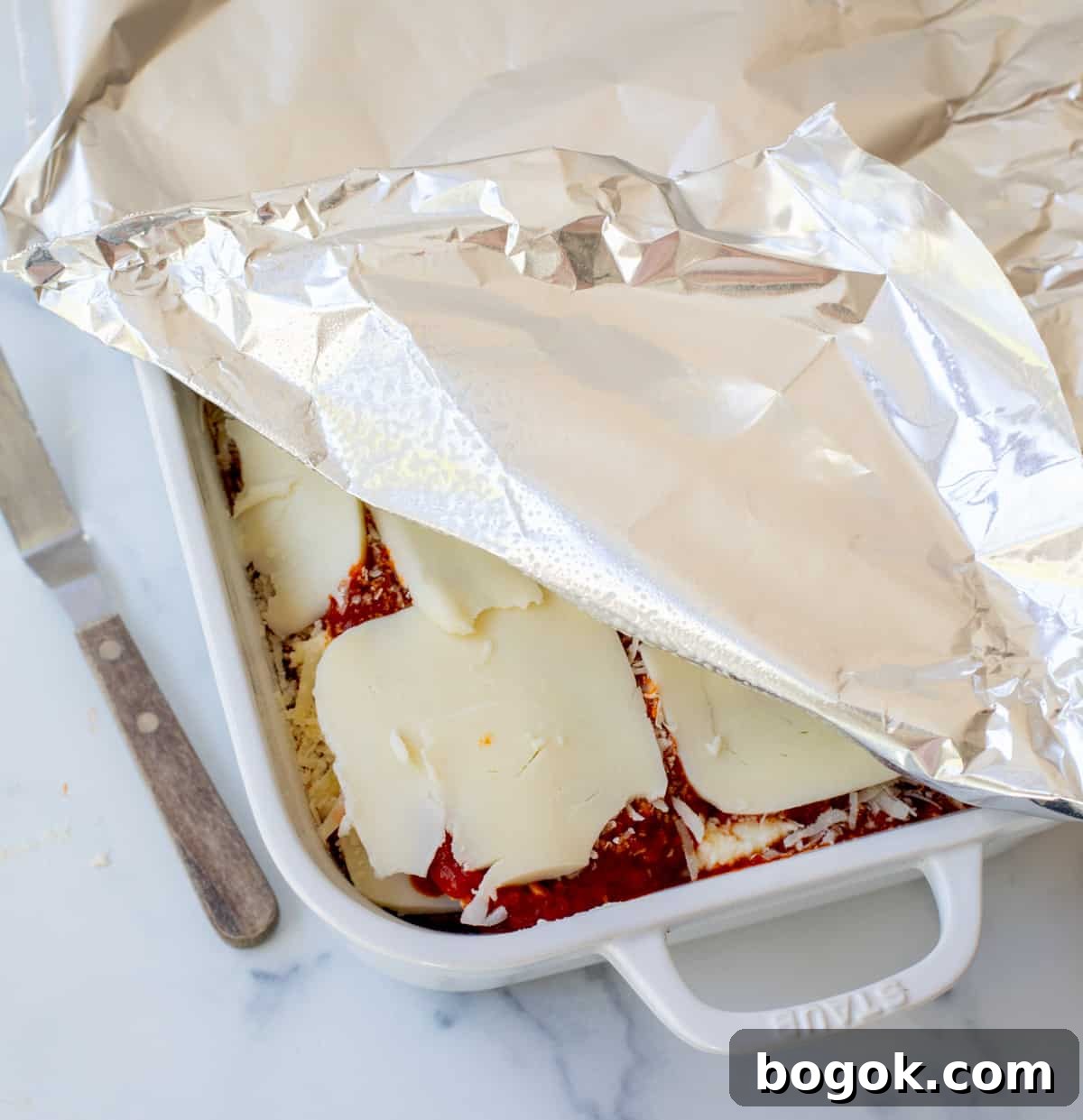 Ultimate Homemade Lasagna Recipe for Savory, Cheesy Layers 10 a pan of the best lasagna covered with greased aluminum foil.