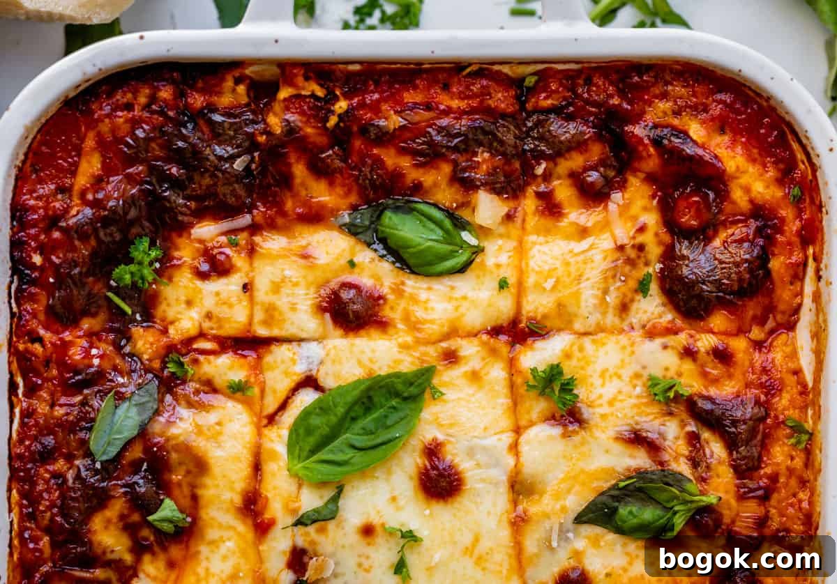 Ultimate Homemade Lasagna Recipe for Savory, Cheesy Layers 6 overhead shot of a pan of lasagna topped with basil.