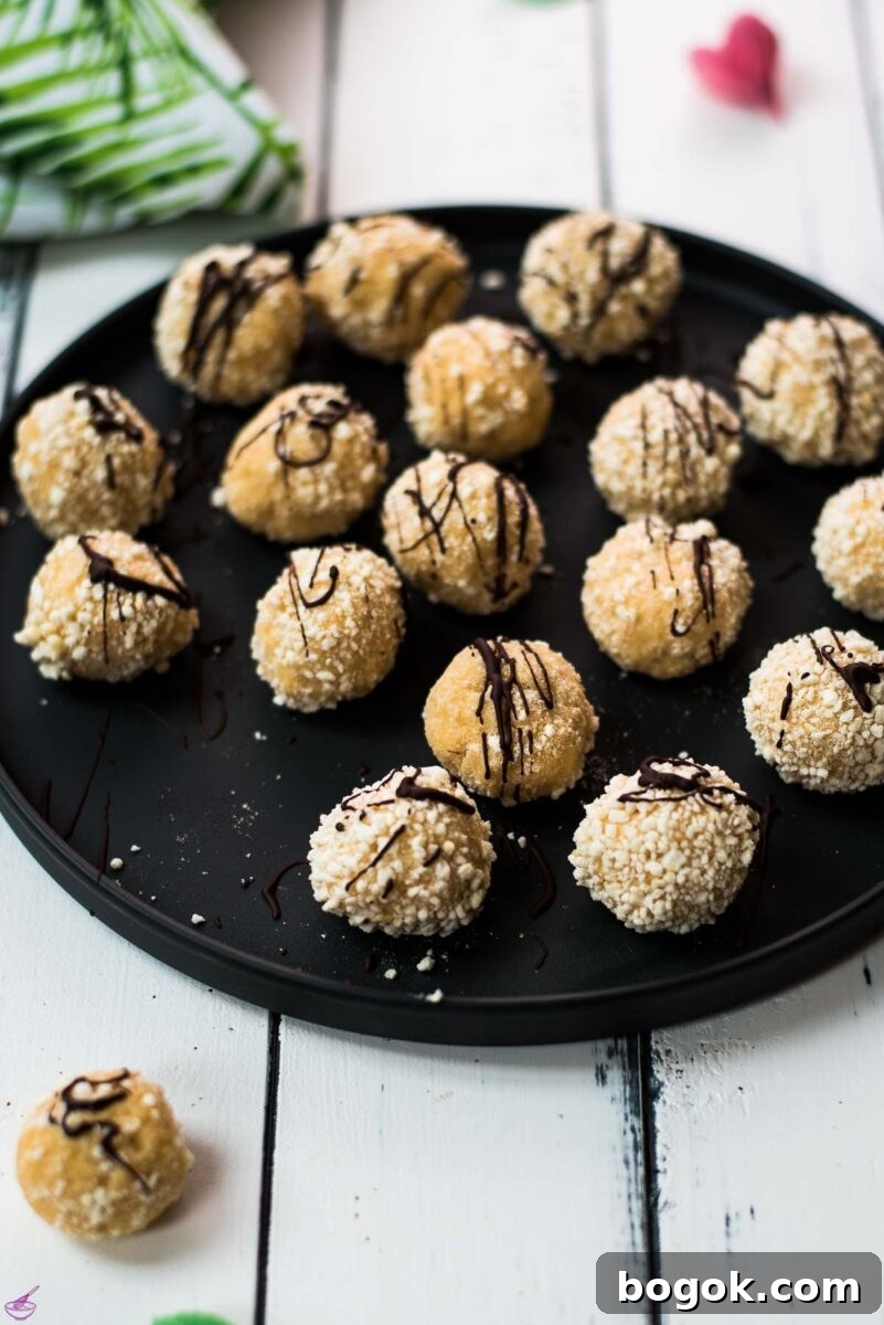 Gorgeous mascarpone eggnog cookies, rolled in ladyfinger crumbs and drizzled with chocolate sauce.