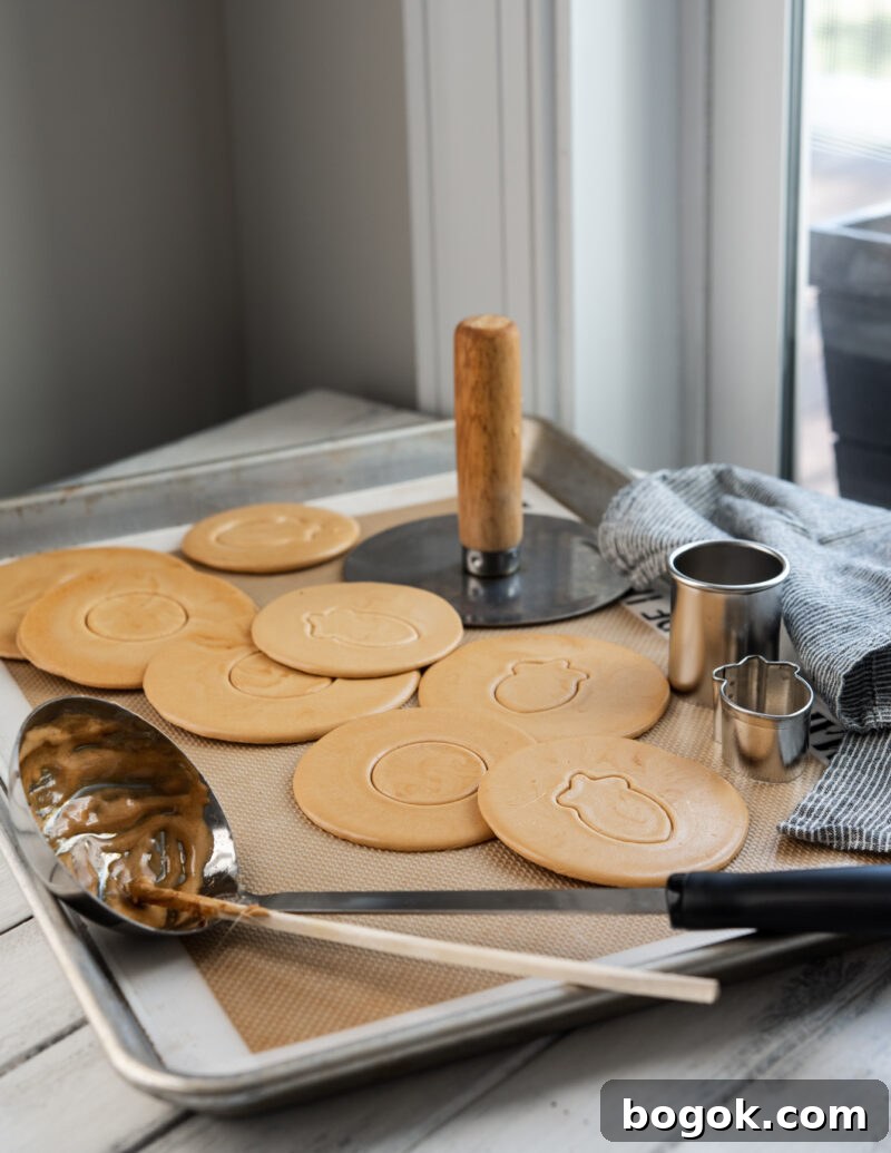 5-Minute Dalgona Candy Recipe: Quick Korean Honeycomb Toffee 2 Dalgona, Korean sugar candy, and a soup ladle are shown with cookie cutters.