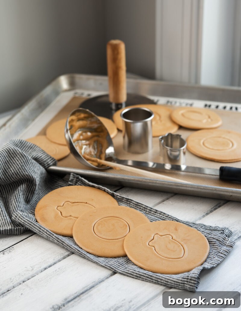 5-Minute Dalgona Candy Recipe: Quick Korean Honeycomb Toffee 3 Korean Dalgona candies are pressed with different patterns of cookie cutters.