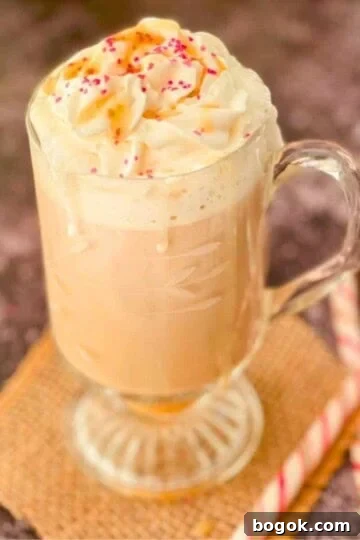 Toasted white chocolate mocha with caramel drizzle and sugar sprinkles, with two candy canes.