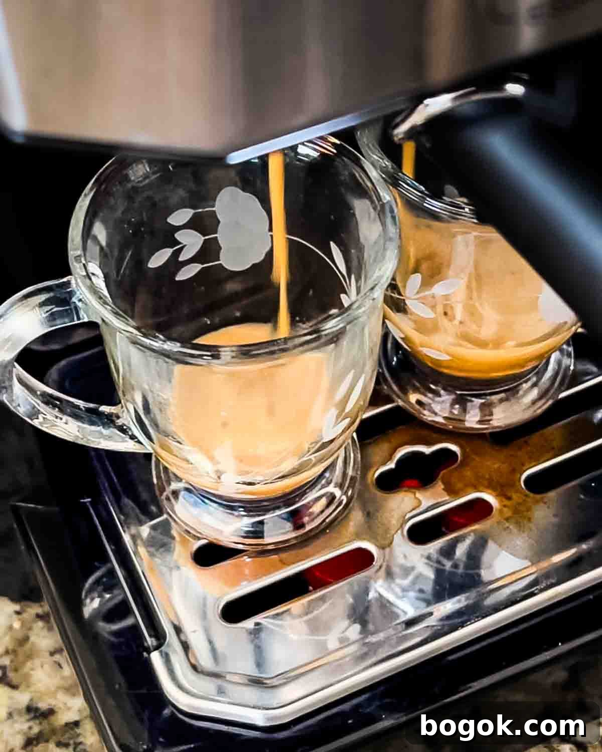 Two shots of espresso being brewed in an espresso machine.