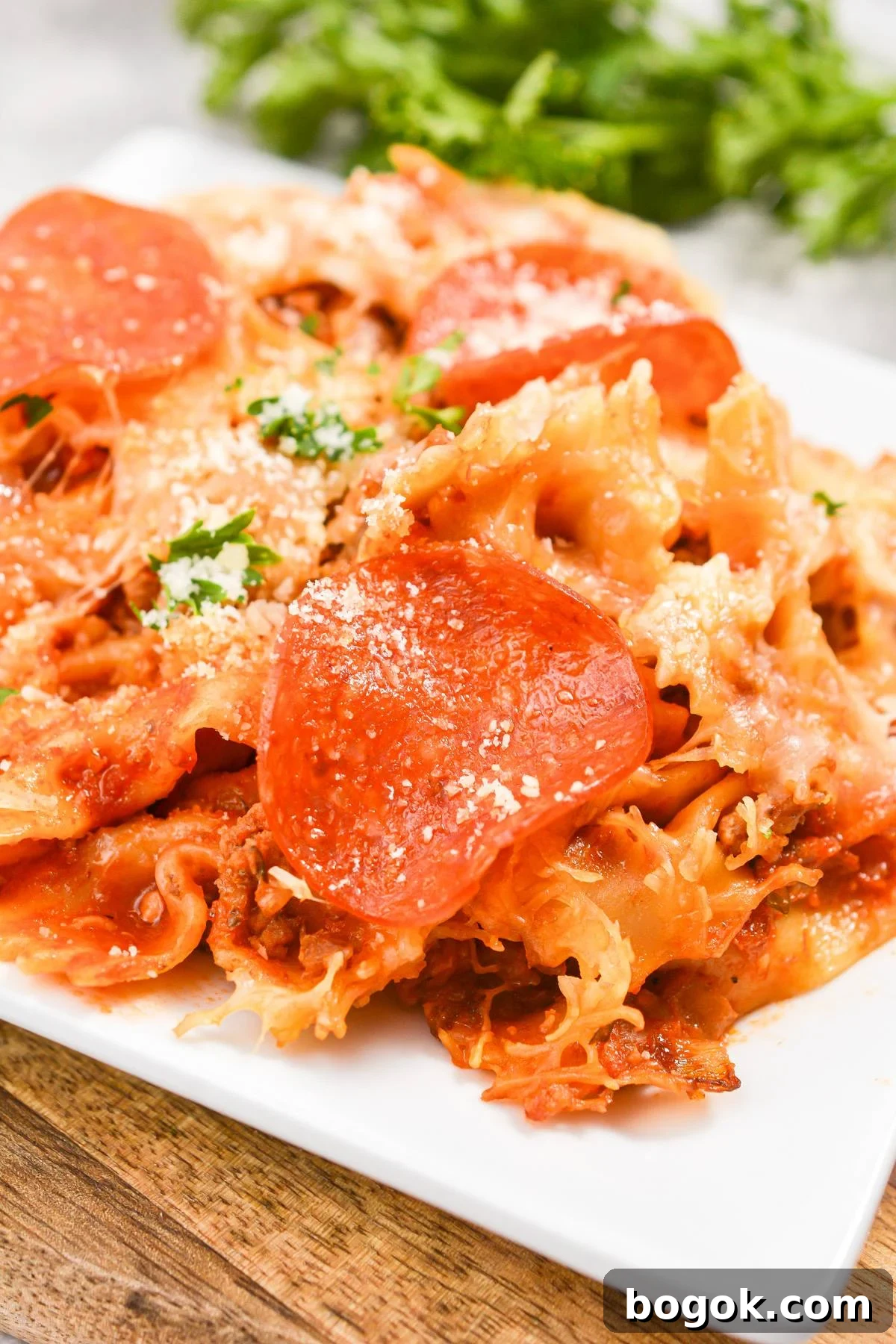 Slow-Cooker Pizza Casserole Recipe for Busy Weeknights 6 A close up of a pizza casserole, topped with pepperoni and garnished with parsley.