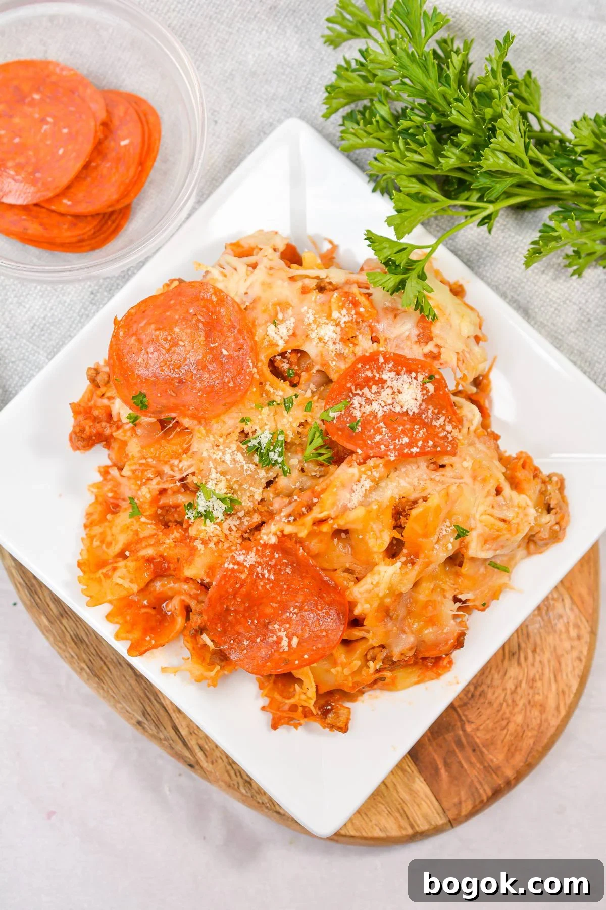 Slow-Cooker Pizza Casserole Recipe for Busy Weeknights 7 An overhead shot of a plate of pizza casserole, topped with pepperoni.