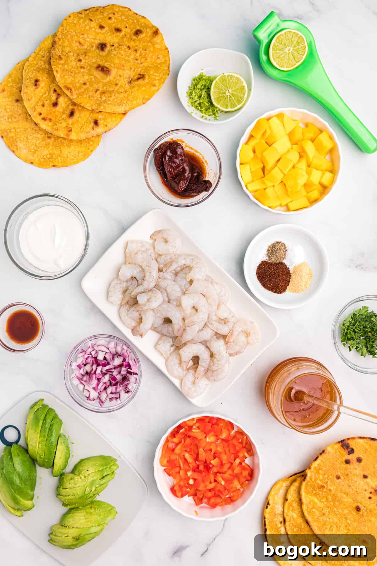 Mango Salsa Grilled Shrimp Tostadas with Chipotle Cream 3 The ingredients for tostadas are placed on a white surface.