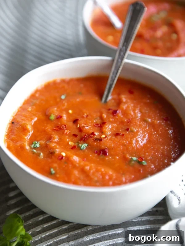 Creamy Broccoli and Cauliflower Soup Recipe for Comforting Meals 11 White soup bowl filled with homemade tomato basil soup.