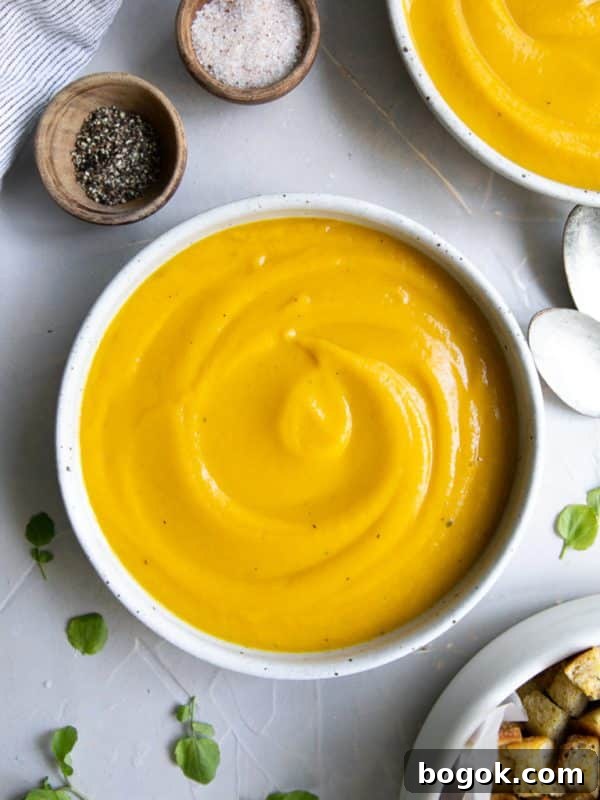 Creamy Broccoli and Cauliflower Soup Recipe for Comforting Meals 9 Shallow bowl filled with smooth and creamy, blended butternut squash soup.