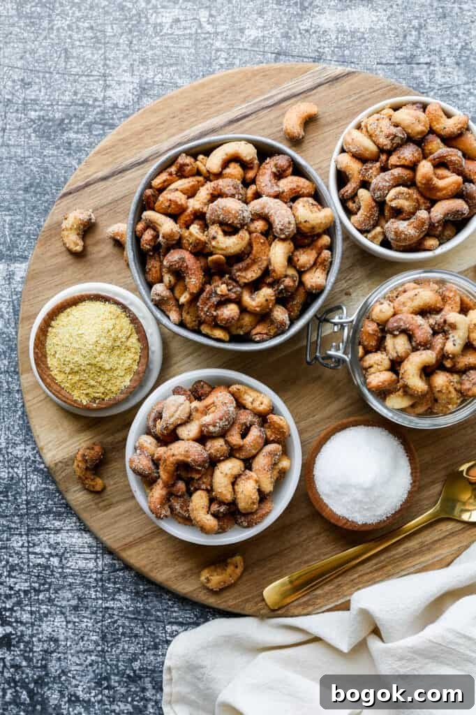 small bowls of air fryer salt and pepper roasted cashews on a round wooden cutting board