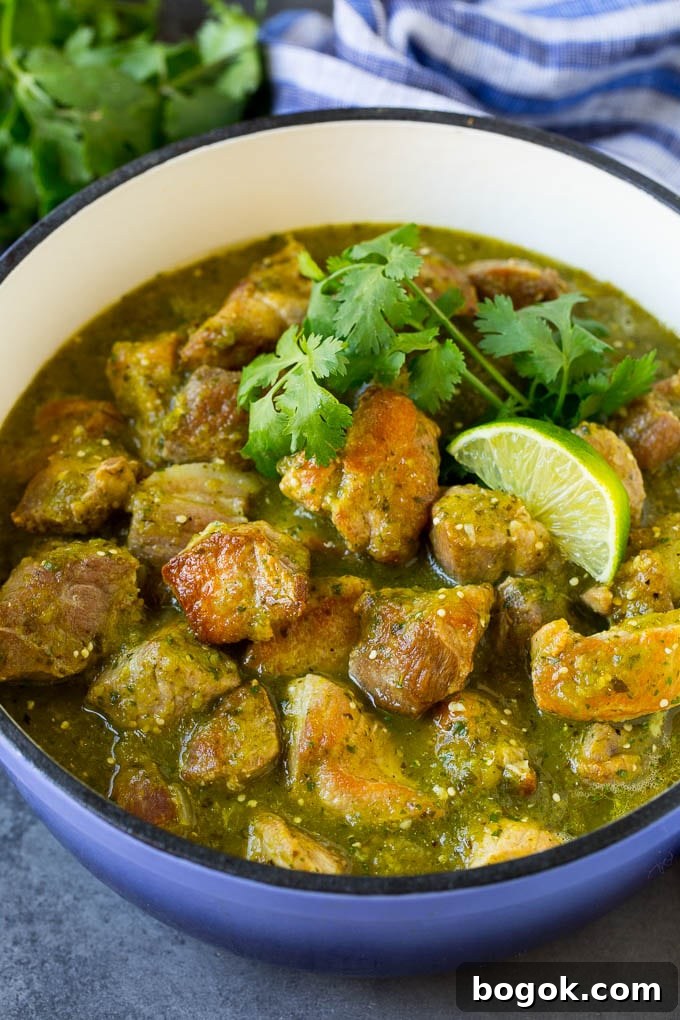 A pot of chile verde topped with cilantro and lime wedges. A pot of chile verde topped with cilantro and lime wedges.