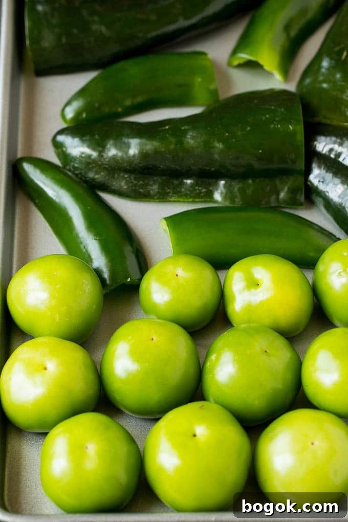 Tomatillos and chiles on a sheet pan. Tomatillos and chiles on a sheet pan.