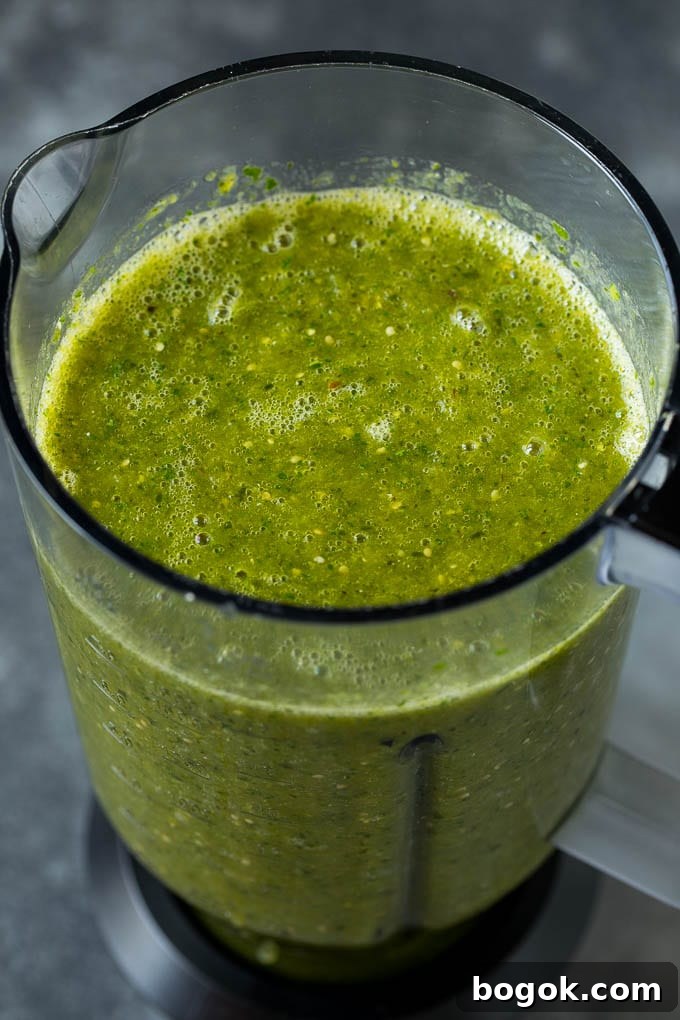A puree of tomatillos, chiles and cilantro in a blender. A puree of tomatillos, chiles and cilantro in a blender.