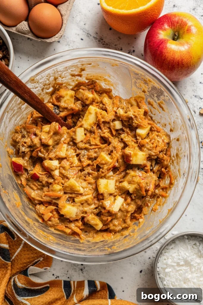 This jumbo morning glory muffins recipe with fruity and nutty add-ins is packed with warm spices for the perfect breakfast bite. Batter for the muffins.
