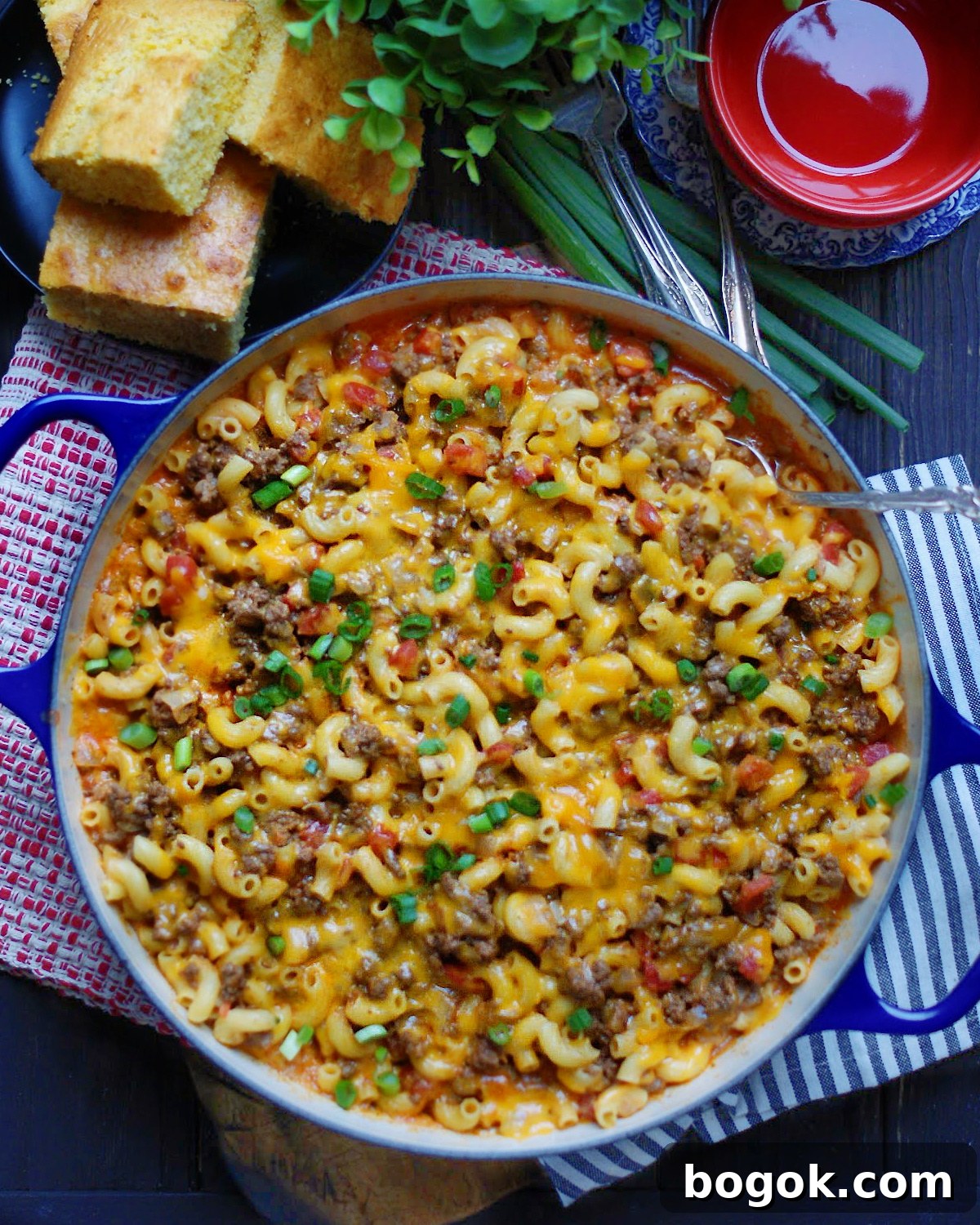 a dutch oven filled with easy chili mac casserole made by folding simple stove top macaroni and cheese into hearty beef chili made with DIY chili seasoning.