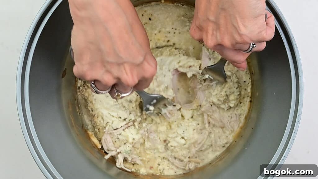 shredding chicken in a slow cooker