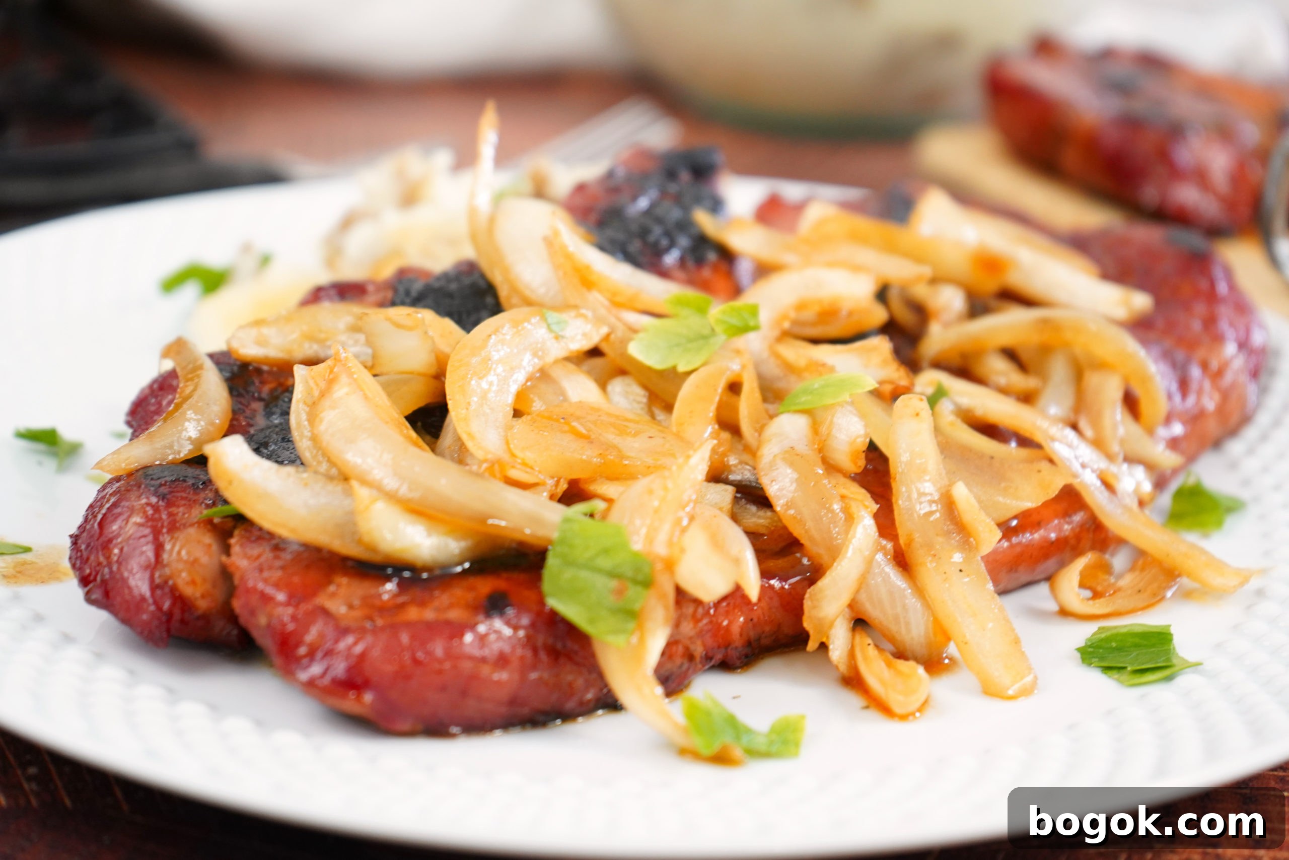 Smoked Pork Steaks with onions on plate. 