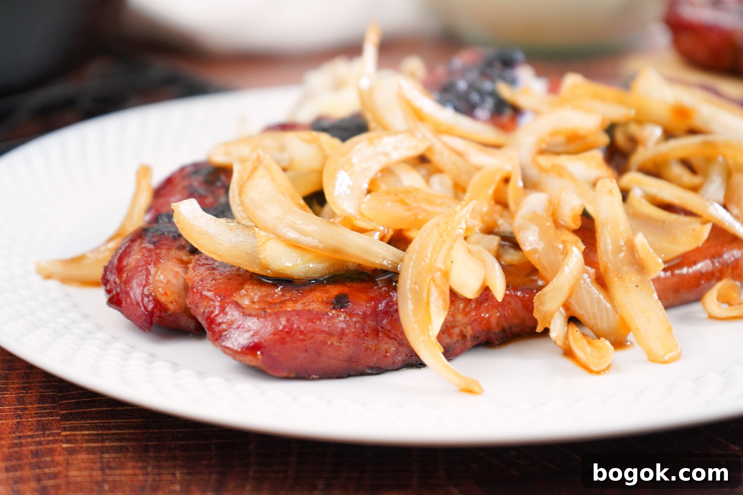Pork Steaks covered in beer braised onions. 