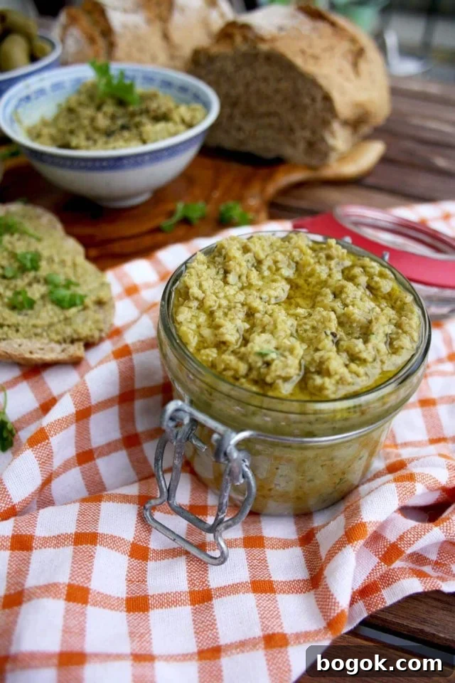 Olive Tapenade Bread Spread with Fresh Bread on Top of the Squared Cloth