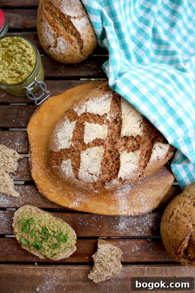 Olive Tapenade - Focus on Bread with Bread Slices around on a Wooden Table