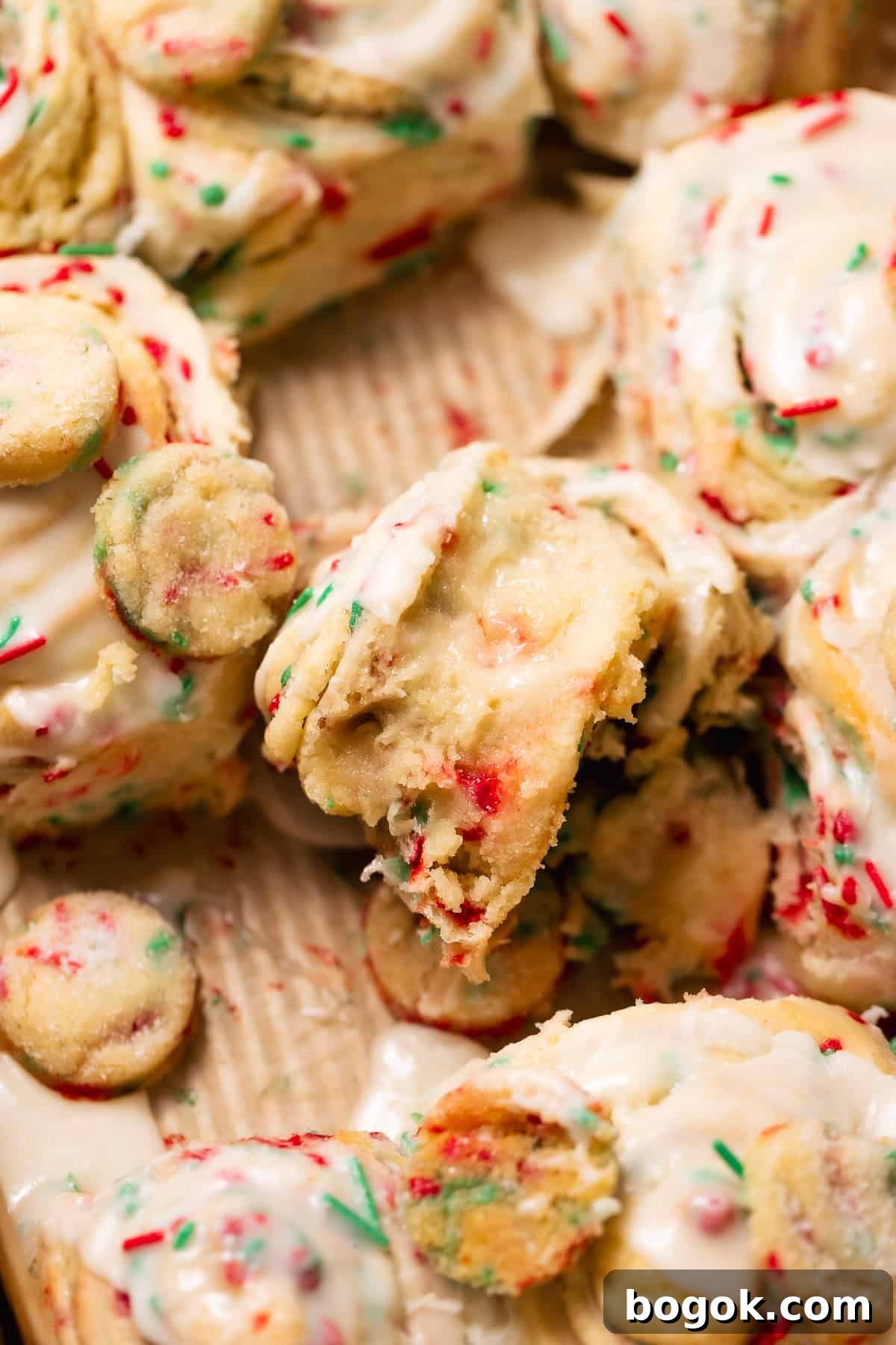 Close-up of a Christmas sugar cookie roll with gooey sugar cookie filling and colorful holiday sprinkles.