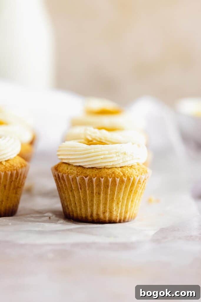 Mango Cupcakes with Luscious Mango Filling 6 the frosted and decorated cupcakes filled with mango puree