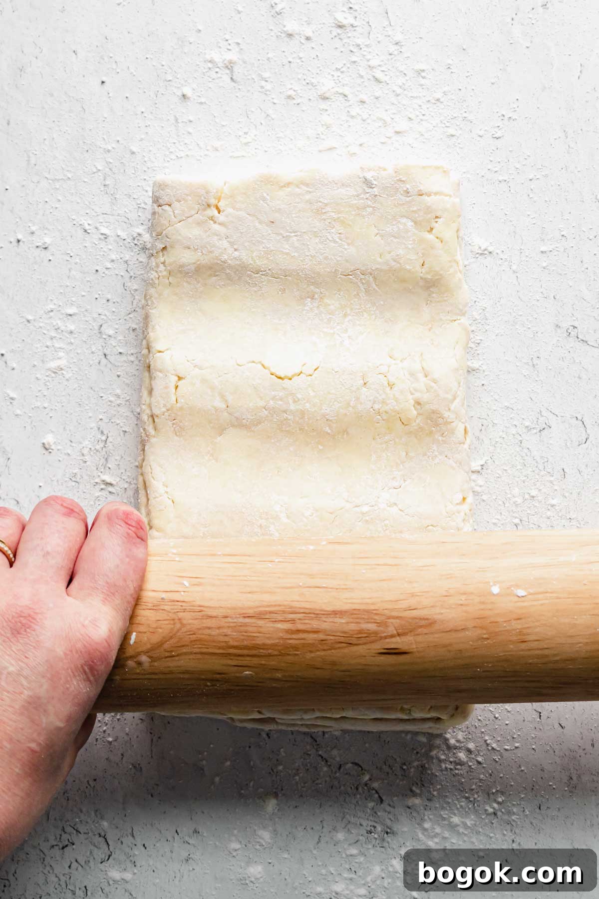 A rolling pin makes indents into the dough before rolling.