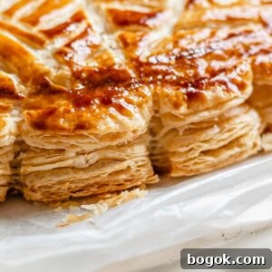 Flaky baked layers of rough puff pastry.