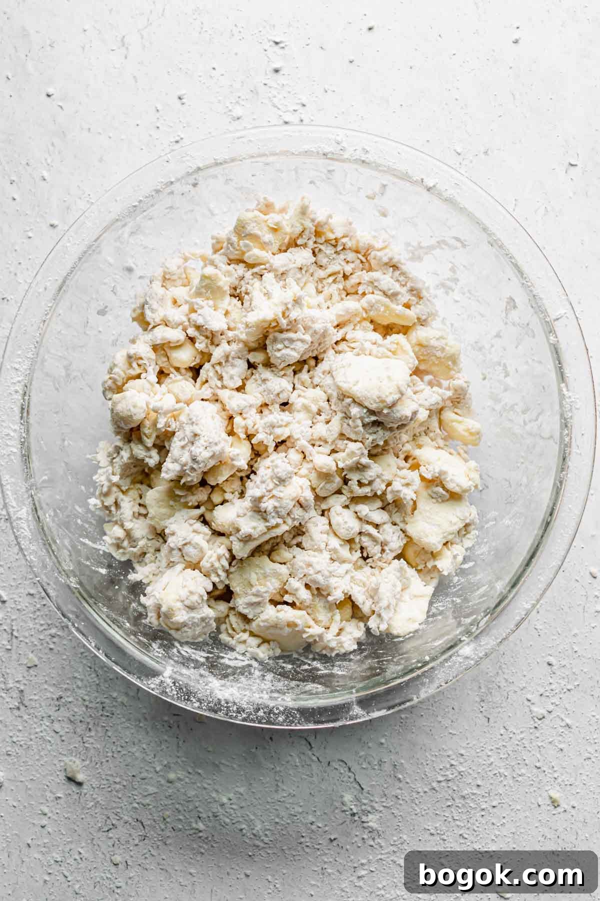 Shaggy dough in a bowl after half of the water has been added.