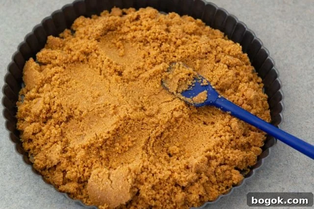 How to Make Graham Cracker Crust by Pressing Crumbs Into the Pan with Spatula