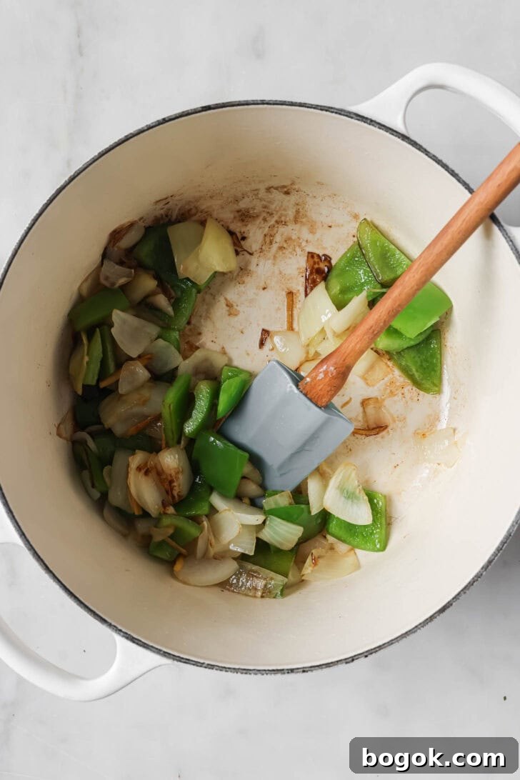 Sauteing vegetables in a pot for Honey Ginger Chicken.
