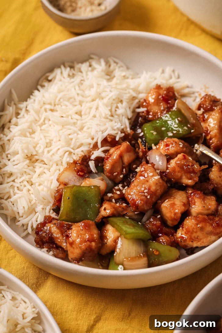 Close up of a plate of Honey Ginger Chicken with rice ready to be eaten.