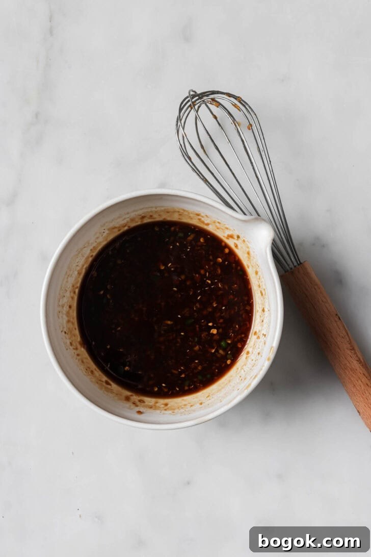 Honey Ginger Chicken Sauce ingredients whisked together in a bowl.