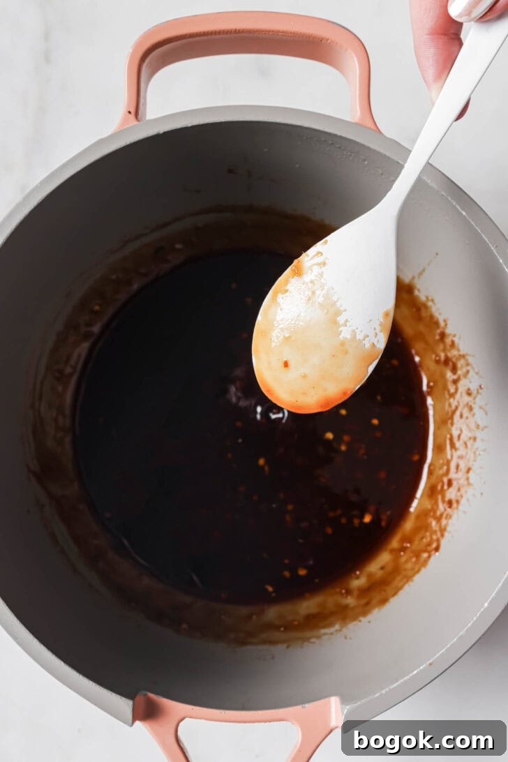 Showing how sauce coats a spoon for the right consistency.