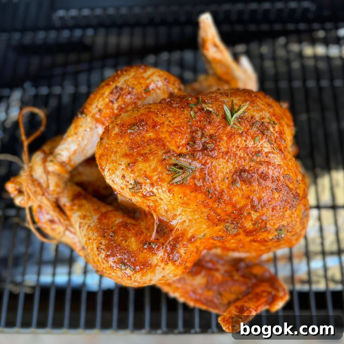 Savory Smoked Turkey Recipe for Tender, Juicy Results 8 on the traeger smoker raw brined turkey with bbq rub seasoning and thyme and rosemary.