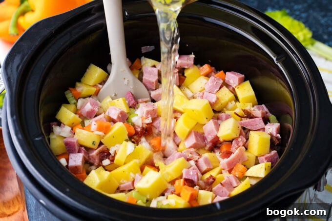 Creamy Slow Cooker Ham & Potato Soup Recipe 5 Combining the ingredients for slow cooker ham and potato soup.