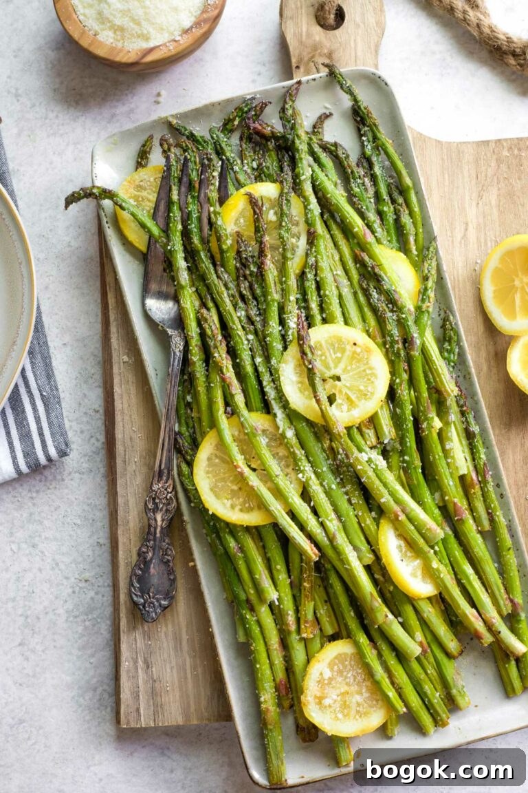 Grilled asparagus on platter with lemon and parmesan