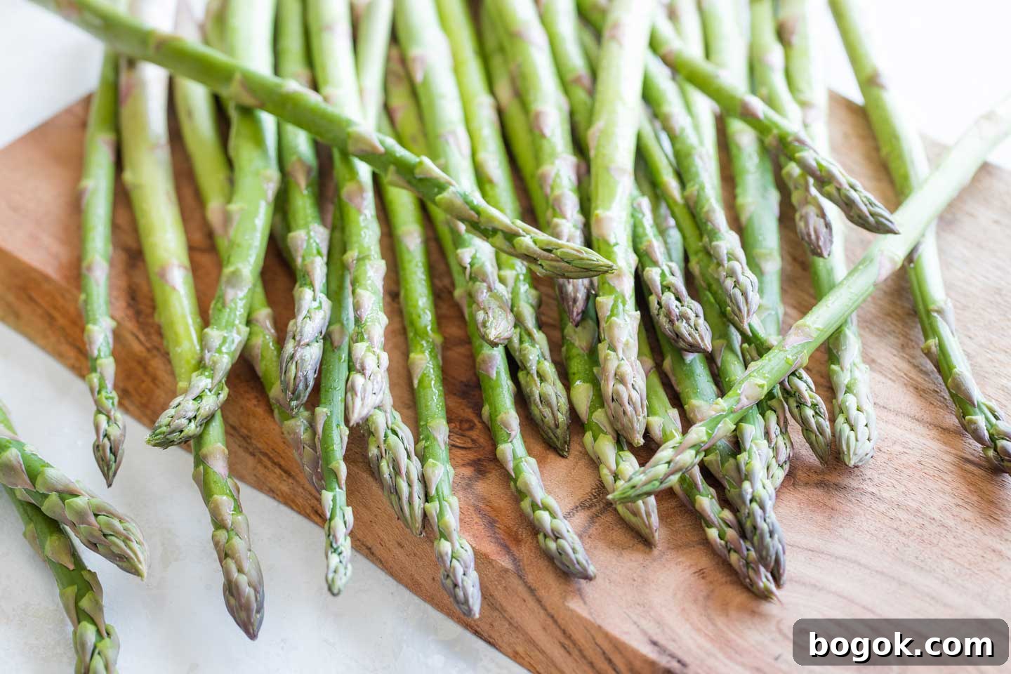 Overhead closeup of really fresh asparagus spears damp with water droplets.