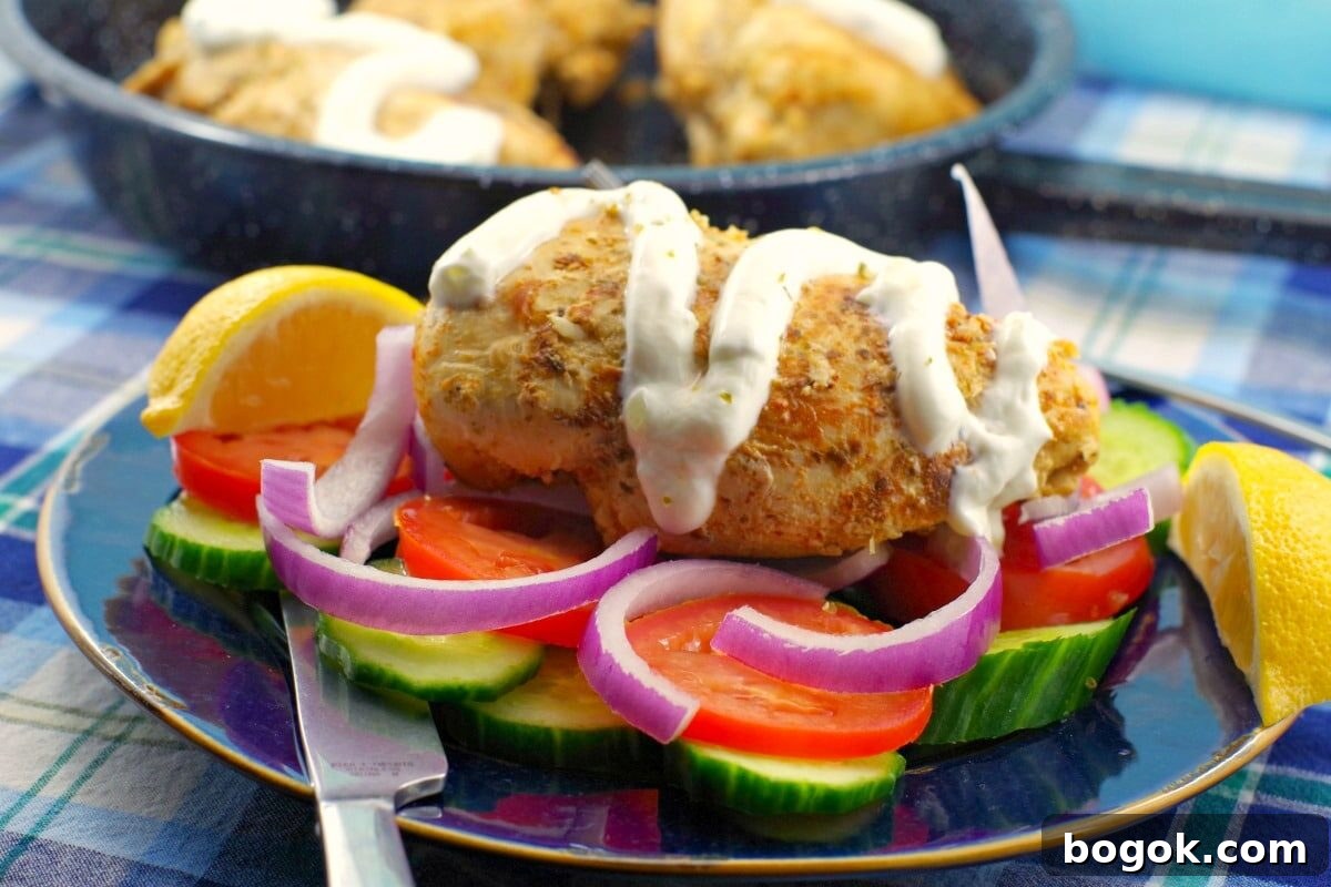 Greek Chicken breast Souvlaki with tzatziki drizzled on (with no pita and no skewer) on a bed of fresh vegetables