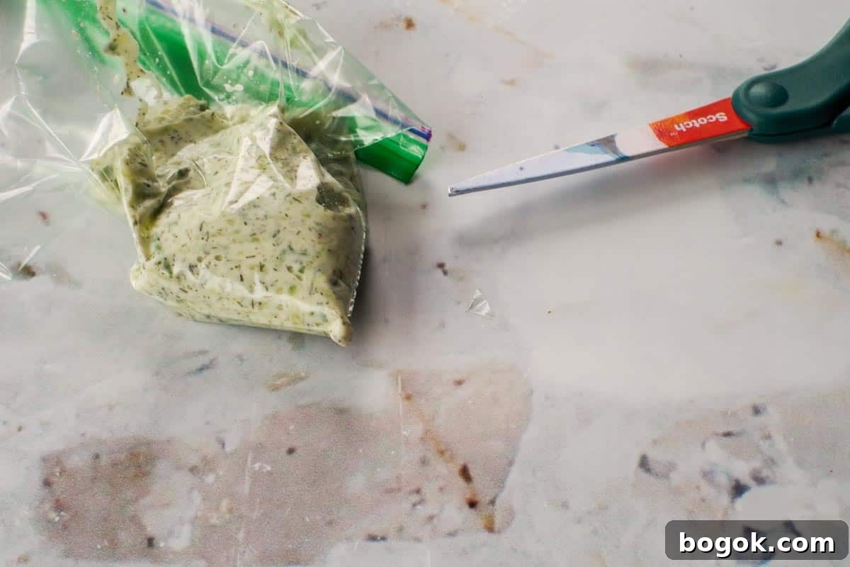 Greek Chicken Souvlaki Without Skewers — Weight Watchers Recipe 12 Tzatziki in ziploc bag with tip cut off and scissors beside the bag.