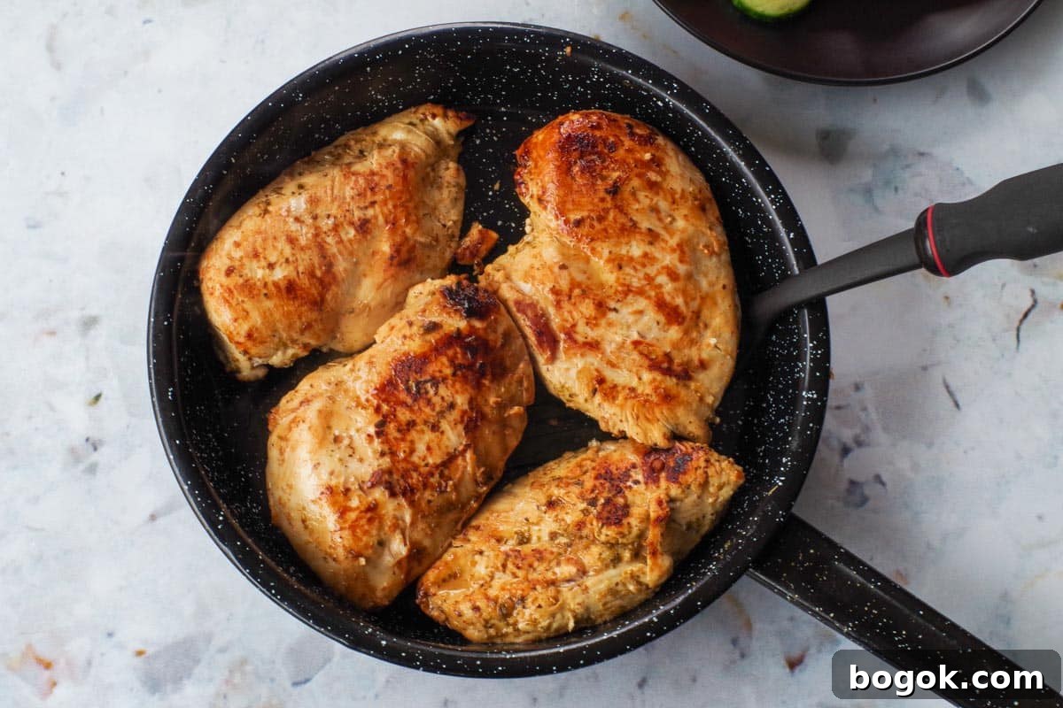 Greek Chicken Souvlaki Without Skewers — Weight Watchers Recipe 9 Cooked chicken breast in frying pan.