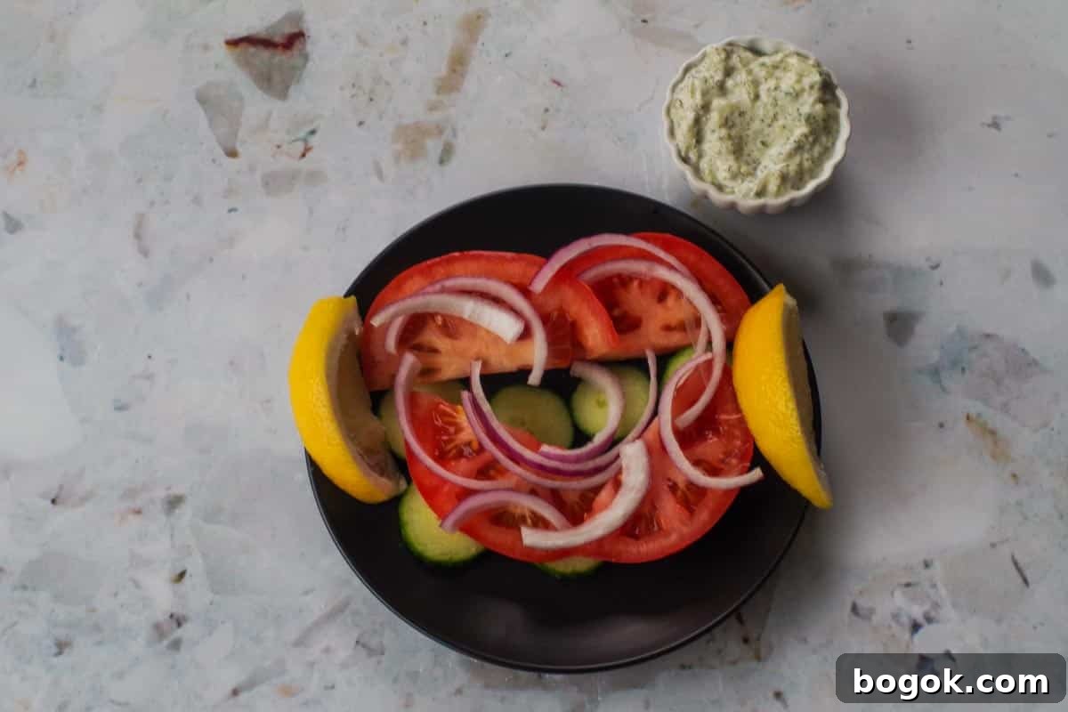Greek Chicken Souvlaki Without Skewers — Weight Watchers Recipe 10 Vegetables on black plate.