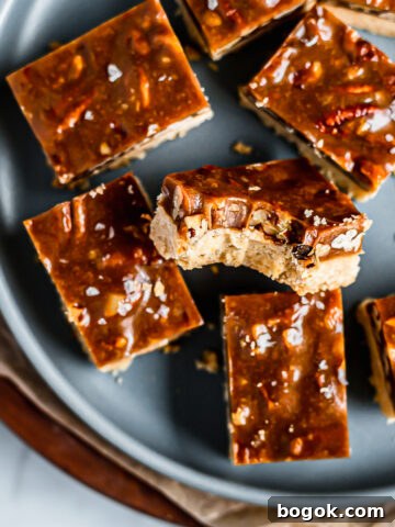 Caramel pecan bars on a blue plate.