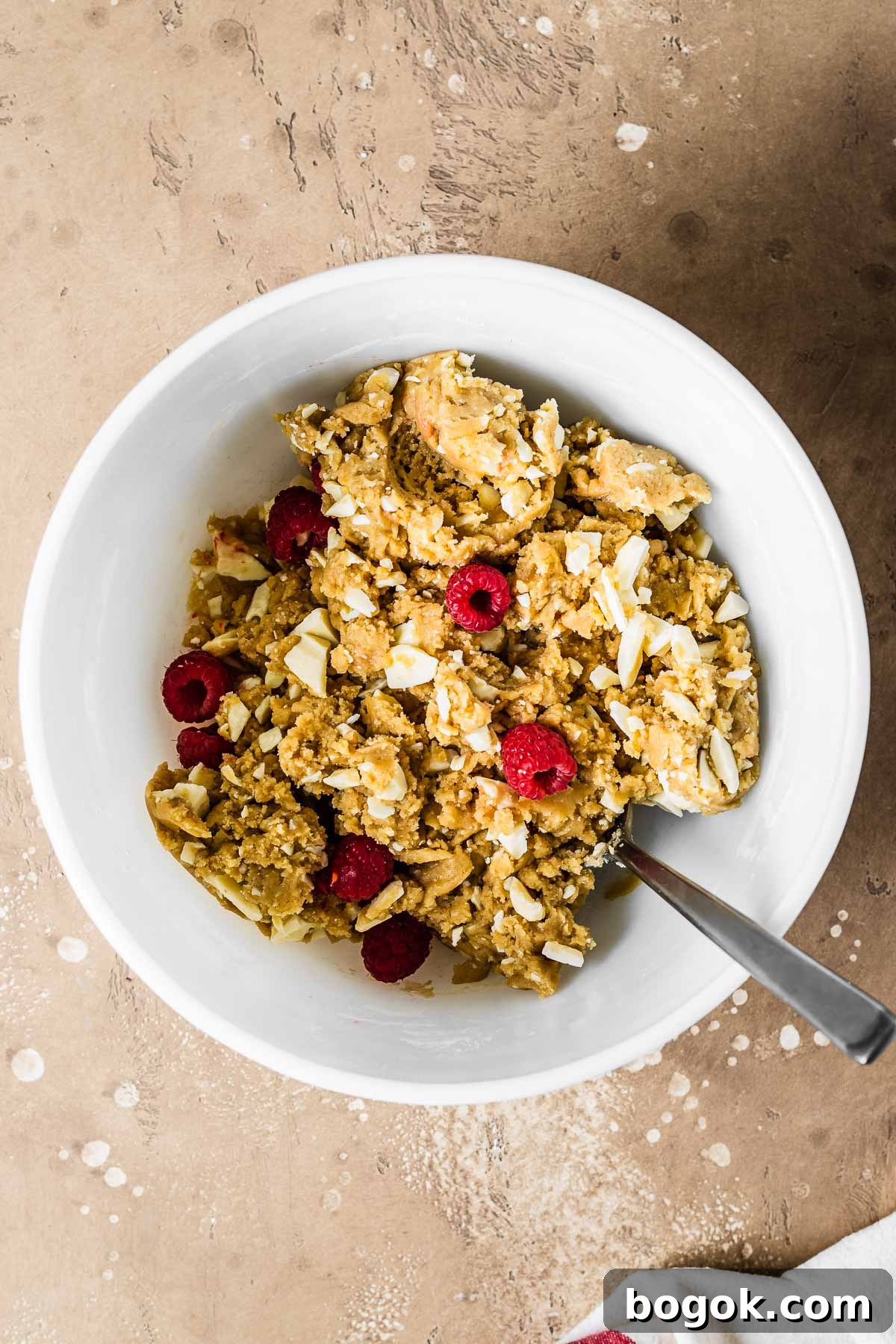 Raspberry White Chocolate Blondies Recipe with Crispy Edges 7 Raspberry and white chocolate blondie dough in a mixing bowl.