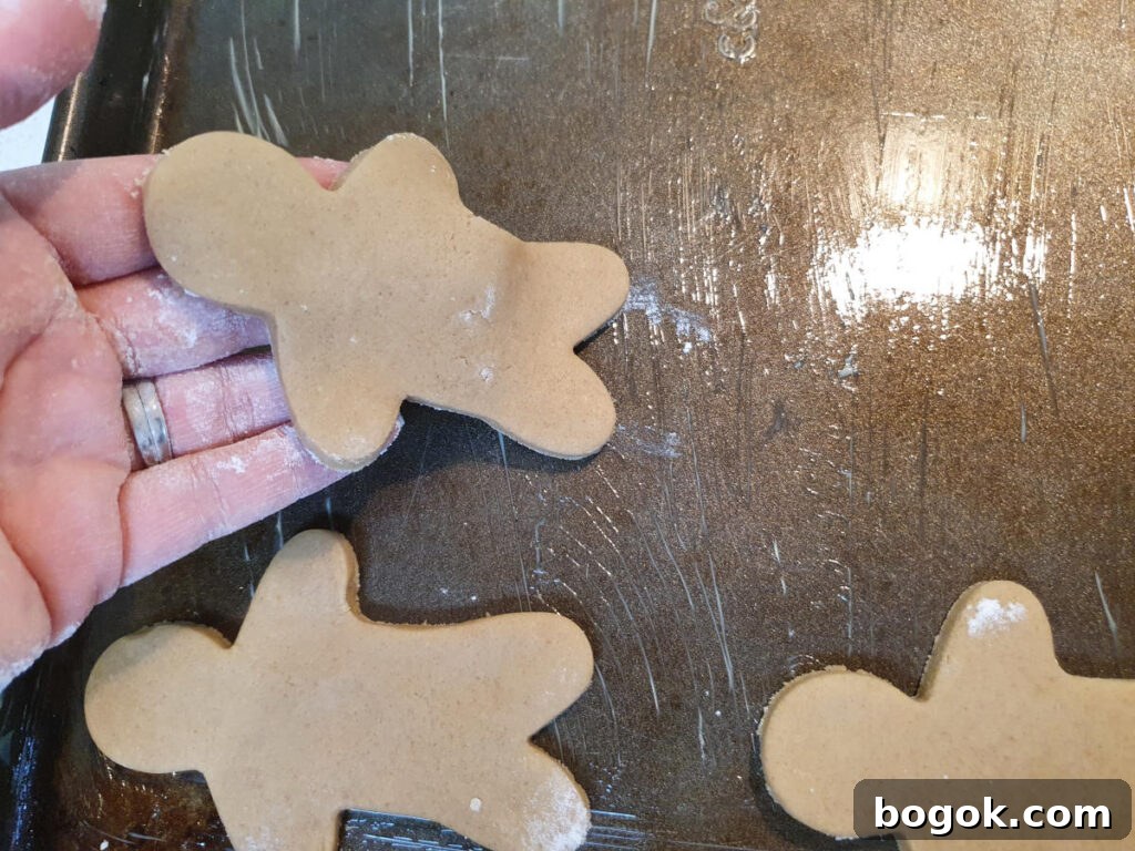 laying out gingerbread men on baking trays.