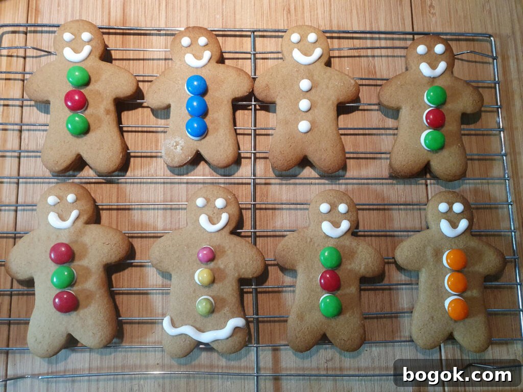 decorated gingerbread men on wire rack drying.