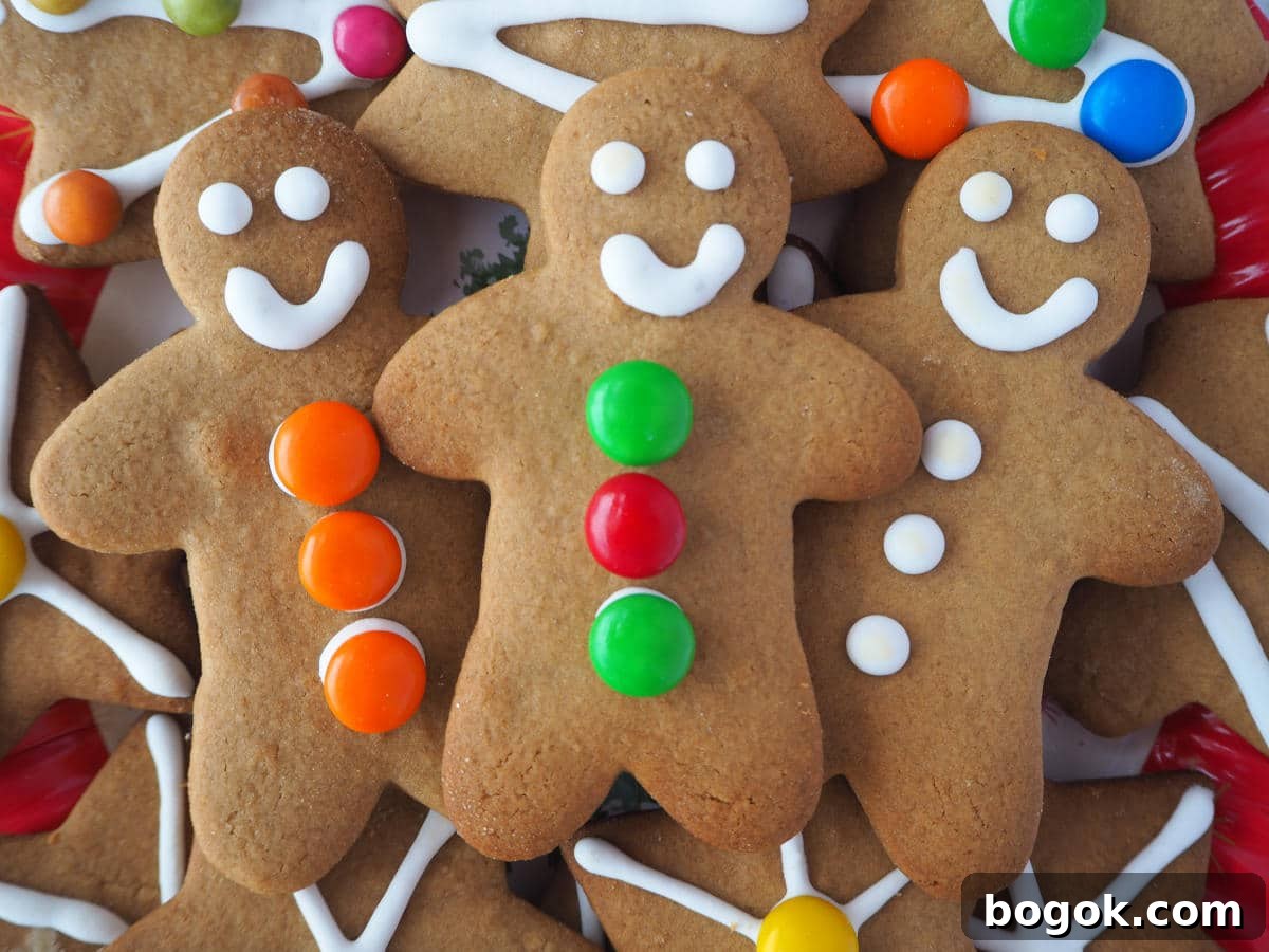 close up of three gingerbread men surrounded by other decorated gingerbread.