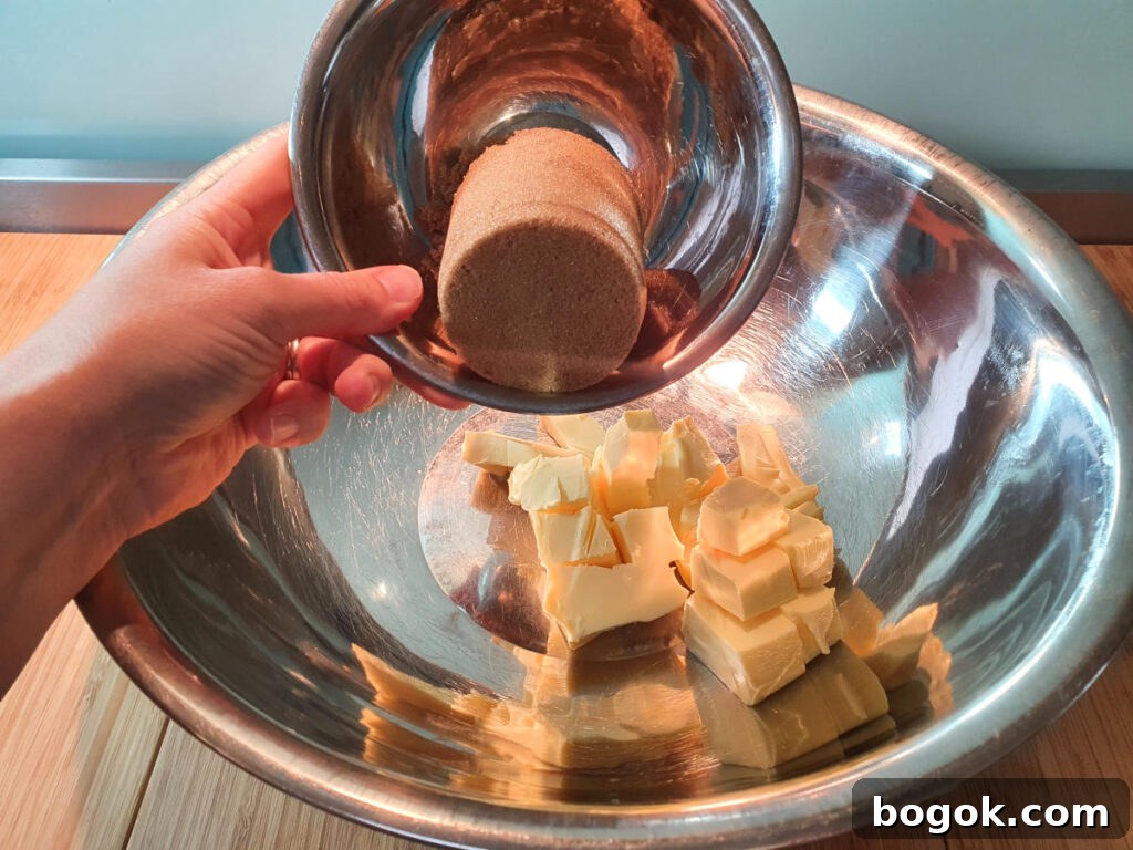 adding brown sugar to room temperature butter in a large mixing bowl.
