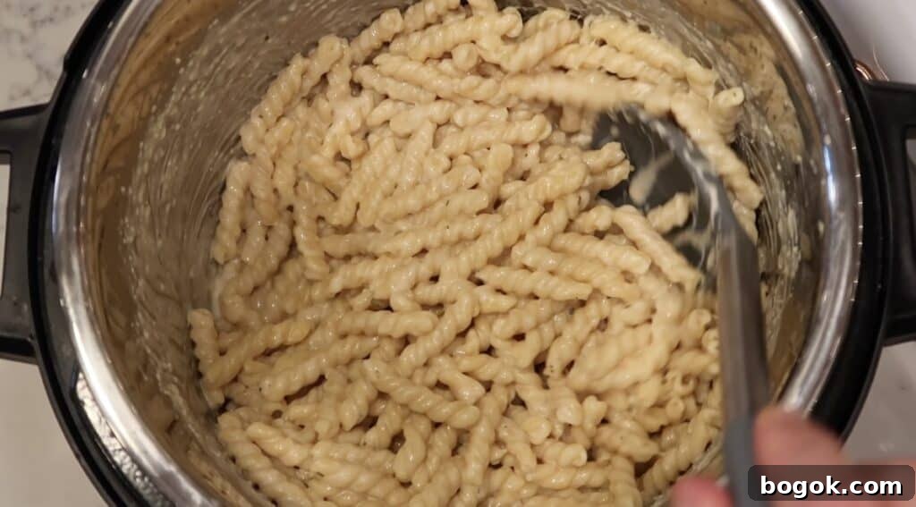 Garlic Herb Cheese Pasta Made in the Instant Pot 10 Stirring everything in the pot until a cheesy sauce forms and coats the pasta